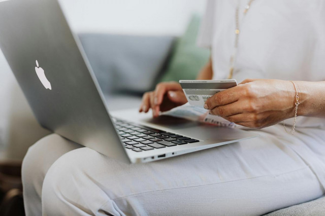 Kvinna med kreditkort shoppar online